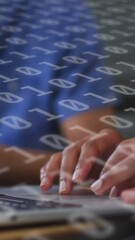 Animation of binary coding over diverse business people using laptop