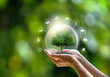 © Dee karen - Energy of a sustainable natural gas business Earth protection green tree on hand with icon summer background tropical nature ecology and environment