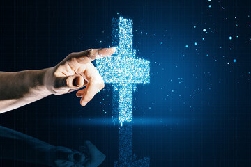 Close up of man hand pointing at creative glowing medical cross plus hologram on dark background. Healthcare and digital transformation concept.