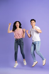 full body image of asian couple posing on purple background