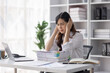 © David - Asian women are stressed or has sore throat at office while working on laptop, Tired asian businesswoman with headache at office, feeling sick at work, copy space