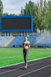 fitness woman running on track in stadium. Training in summer. Sport, healthy lifestyle concept