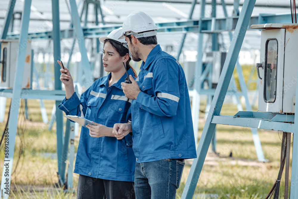 Solar electric installer and practitioner inspect electrical systems