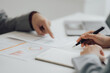© Kritdanai - Young colleagues discussing business and price chart analyzes business people on the table great in modern coworking office teamwork concept. Calculate personal tax for customers