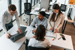 © standret - Conception of teamwork. Four people are in the office together