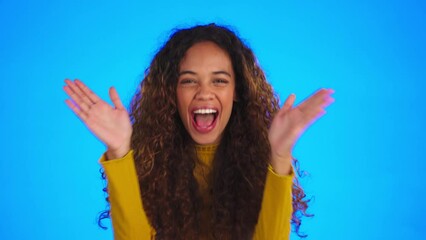 Wall Mural - Funny face, humor and joking with a woman on a blue background in studio laughing while feeling playful. Portrait, hands and change of expression with a happy young female for comedy or laughter