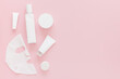 Set of cosmetic products for face care in white color on a pink background. Beauty. Self care. Moisturizing the skin of the face. Cream, face mask, toner. Copy space. Place for text.