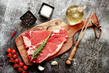 Poster - raw T-bone steak on stone background