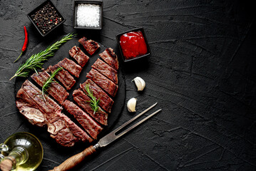 Wall Mural - grilled T-bone steak on stone background with copy space for your text