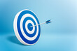 © ADDICTIVE STOCK - Round shaped target with arrow on blue background