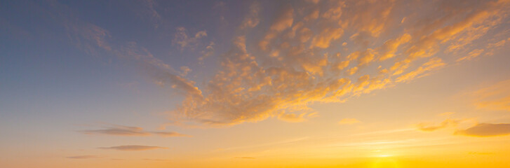 clouds and orange sky,Real majestic sunrise sunset sky background with gentle colorful clouds without birds.Panorama, large