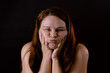 © Юля Бурмистрова - Young funny woman puff out and pop cheeks with hands. Female portrait isolated on black. Cheerful girl pouting and making faces. Feelings, gesturing. Human emotions, facial expression concept.