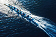 © VisualProduction - Rowing team on blue water. Top down view. Generative ai.