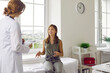 © Studio Romantic - Children and medicine. Smiling teenage girl talks about her health to female doctor during appointment in medical office. Caucasian child is sitting on medical couch and talking to woman in white coat