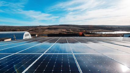 Wall Mural - Multiple solar panels on the roof of a manufacturing building