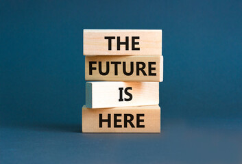 Wall Mural - The future is here symbol. Concept words The future is here on wooden block. Beautiful grey table grey background. Motivational business the future is here concept. Copy space.