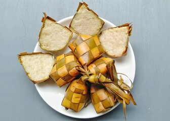 Ketupat, special dish served at Eid Mubarak or Ied Fitr celebration in Indonesia. Ketupat is  is a type of dumpling made from rice packed inside a diamond-shaped container of woven palm leaf pouch.