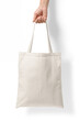 Female hand holding a blank tote canvas bag mockup isolated on a transparent background, PNG. High resolution.