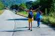 © Sangiao_Photography - Mid Couple walking on the road. Danger traffic safety education for tourism transportation.