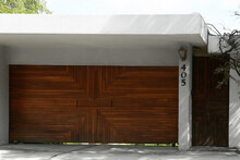 Beautiful New Automated Wooden Gates And White Wall Outdoors