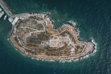 Wall Mural - Aerial sunset view of Kusadasi castle, historical place with a lighthouse in Turkey