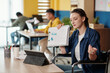 © DragonImages - Young businesswoman with disability showing chart to coworker in online meeting