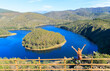 Melero meander in Las Hurdes, Extremadura in Spain- Woman sitting and looking at panoramic view 