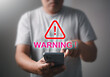 Businessman using smartphone with warning sign, Caution in investing Economic situation warning, Banking and cyber security innovation technology, Exclamation mark concept