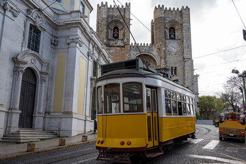 Sticker - Traditional yellow tram in front of Lisbon Cathedral in Lisbon, Portugal