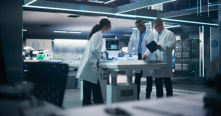 Fototapete - Team of Industrial Engineers Working on a Mobility Robot at a Startup Factory. Multiethnic Male and Female Scientists Discussing an Automated AI Robotic Delivery Machine in a Laboratory