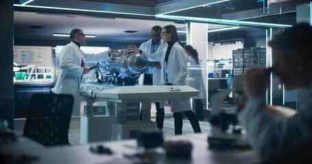 Fototapete - Young Group of Engineers, Project Manager and Machinery Operators Collaborate on a New Type of a Gas Turbine Engine, Standing with Tablet Computer in Scientific Technology Lab