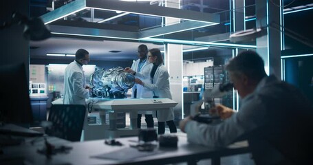 Fototapete - Smart Team of Engineers, Project Manager and Machinery Operators Collaborate on a New Type of a Electric Turbine Engine, Using Tablet Computer and Measuring Tools in Scientific Technology Lab