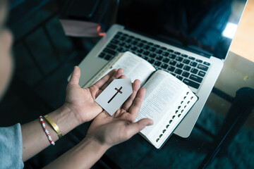 Woman holding paper church icon with computer laptop, Church services online concept, Online church at home concept.