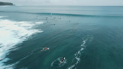 Wall Mural - Surfer ride on wave in blue ocean at Bali. Aerial view