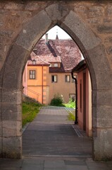 Sticker - View through an archway to a house with old architecture