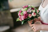 Fototapeta Morze - Bride holding her beautiful bouquet