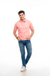 © Niks Ads - Young Indian man wearing basic t-shirt standing and holding hands in pockets.