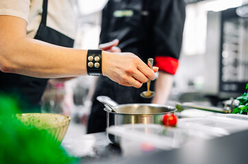 woman chef cooking seafood soup on restaurant kitchen