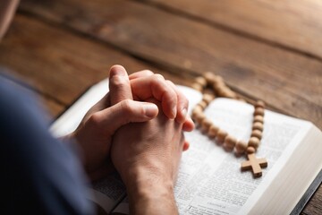 Wall Mural - Man hands praying on the bible. Concept religion