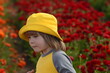 © ShU studio - Ranunculus fields. White buttercup flower A little boy in a yellow panama hat and a yellow T-shirt runs through a flower field. Child view from the back.  children flowers of life