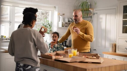 Wall Mural - Family enjoying takeaway pizza in kitchen