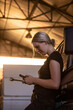 © Austockphoto - Young female aussie mechanic holding tools and leaning on a car in need of repair in workshop garage