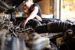 © Austockphoto - mechanic working on car engine in auto repair garage