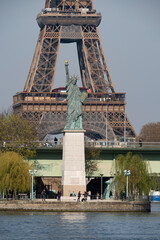 Wall Mural - Paris, France - 04 05 2023: View of the Statue of Liberty, Grenelle bridge from Mirabeau Bridge.