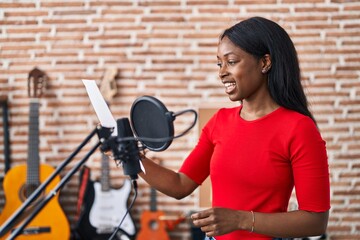 Sticker - Young african american woman artist singing song at music studio