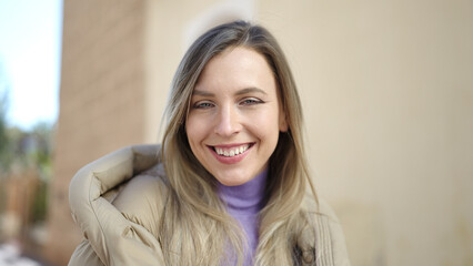 Sticker - Young blonde woman smiling confident standing at street