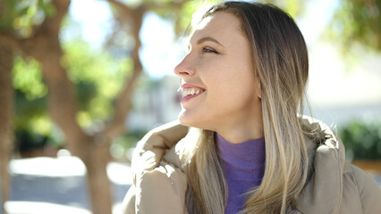 Sticker - Young blonde woman smiling confident looking to the side at park