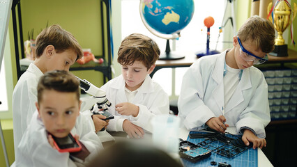 Poster - Group of kids students talking on smartphone repairing gadget at laboratory classroom