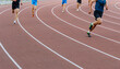 © sports photos - runner leader run ahead of sprint race on turn stadium track, summer athletics championship