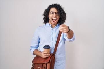 Poster - Hispanic man with curly hair drinking a cup of take away coffee pointing displeased and frustrated to the camera, angry and furious with you